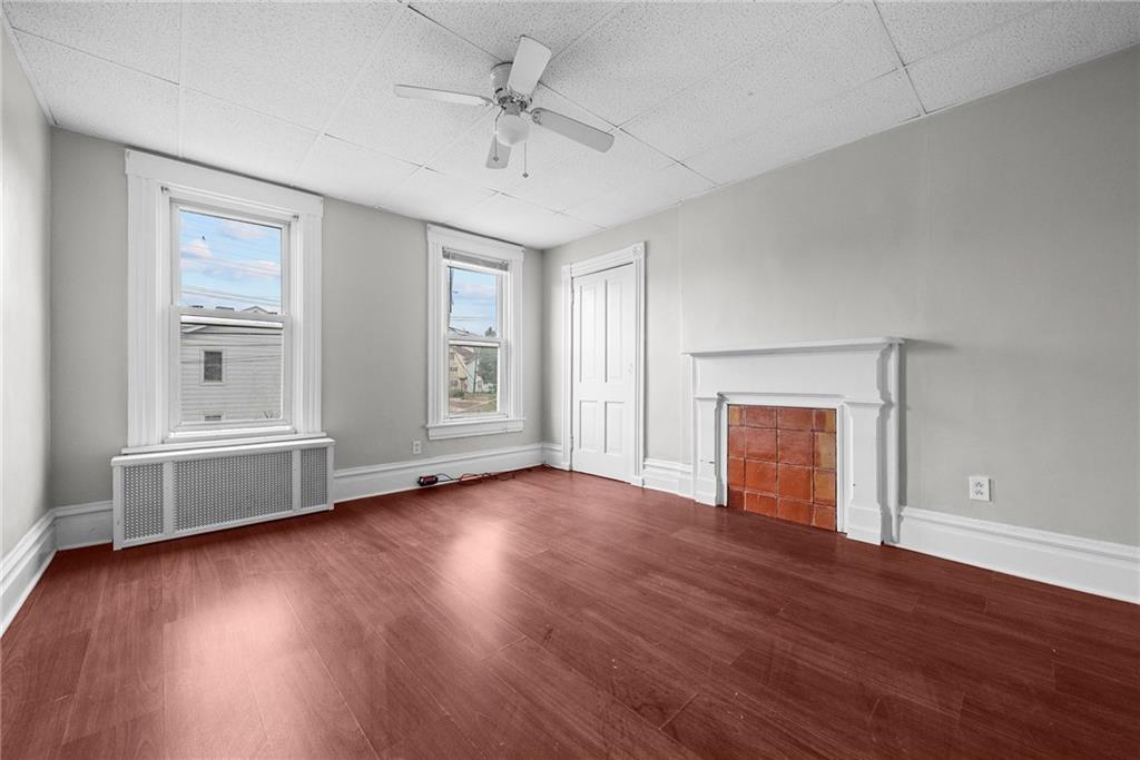 107 Dickman Street Carnegie, PA 15106 - Photo 18 of 47 an empty room with wooden floor chandelier fan and windows