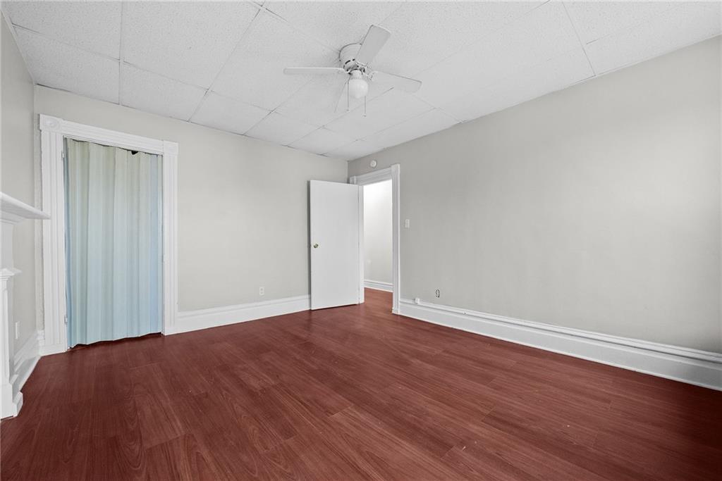 107 Dickman Street Carnegie, PA 15106 - Photo 19 of 47 a view of an empty room with wooden floor and a ceiling fan