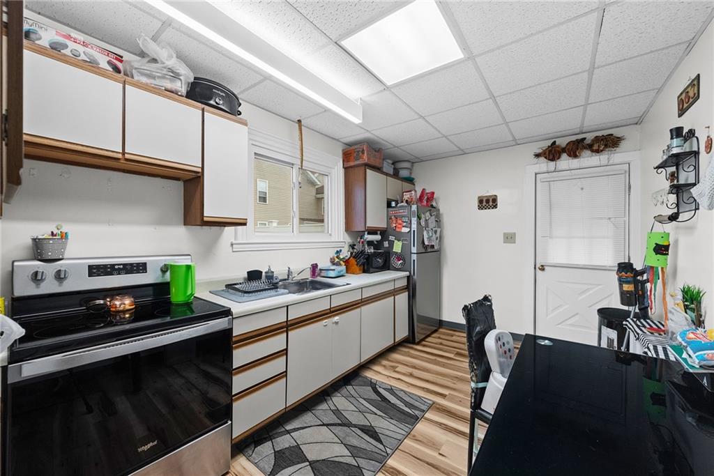 107 Dickman Street Carnegie, PA 15106 - Photo 27 of 47 a kitchen with stainless steel appliances granite countertop a sink stove and cabinets
