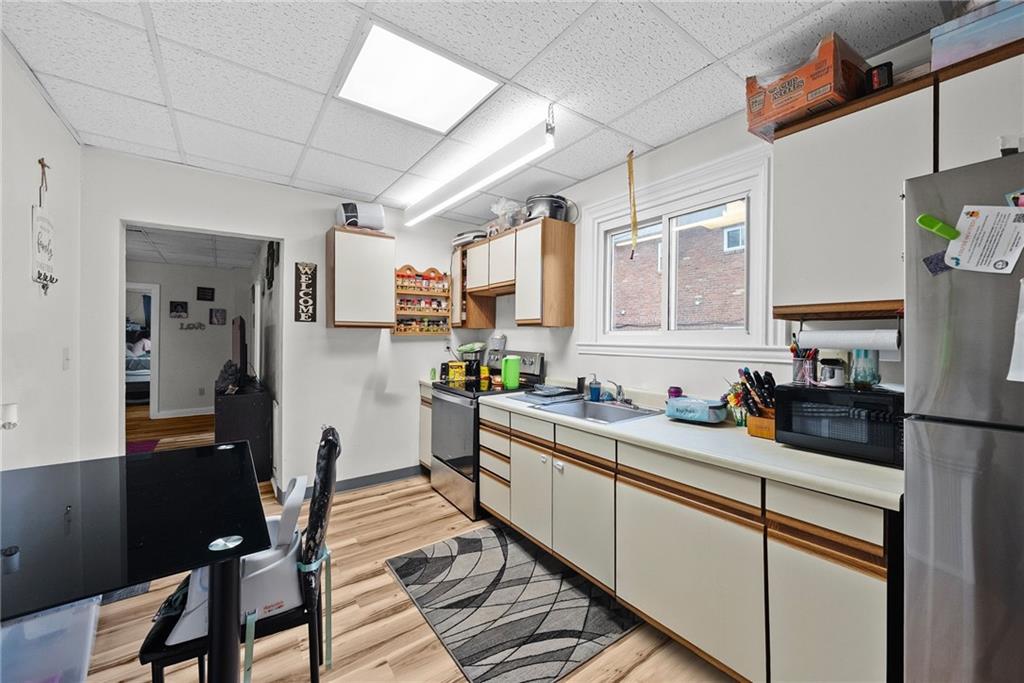 107 Dickman Street Carnegie, PA 15106 - Photo 29 of 47 a kitchen with a sink stove and cabinets