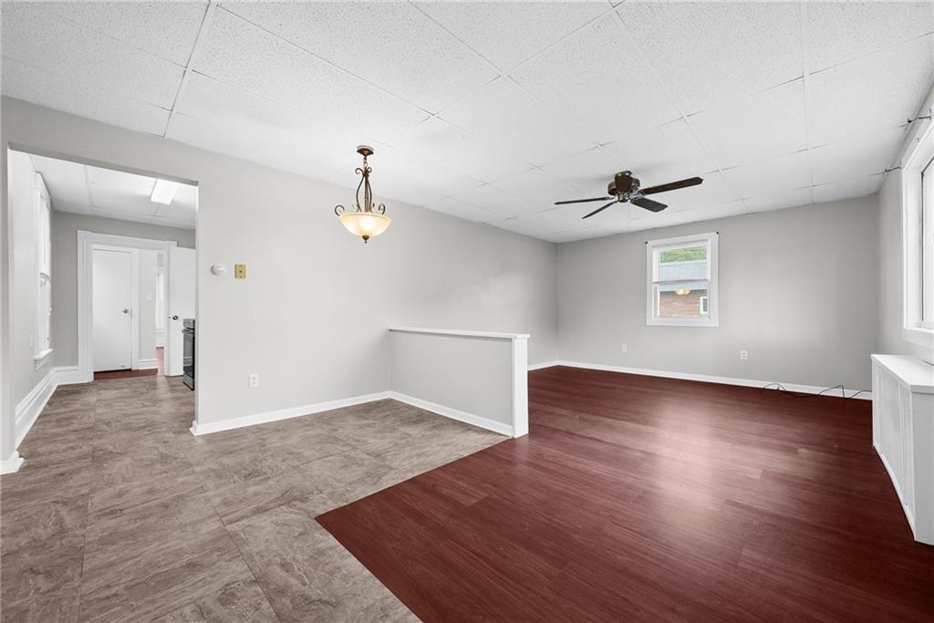 107 Dickman Street Carnegie, PA 15106 - Photo 7 of 47 an empty room with wooden floor chandelier and windows