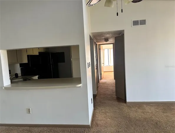 a view of a hallway with wooden shelves