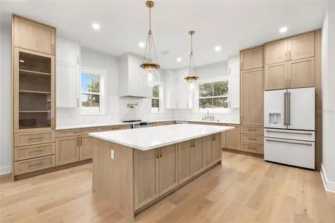 a kitchen with a stove and white cabinets