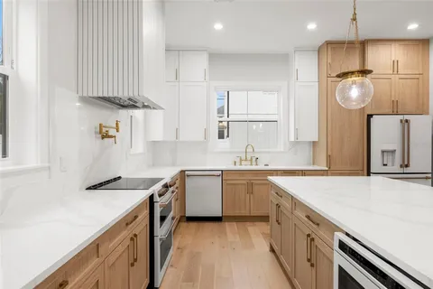 a kitchen with a sink cabinets and window