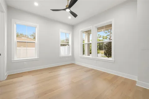 a view of empty room with wooden floor