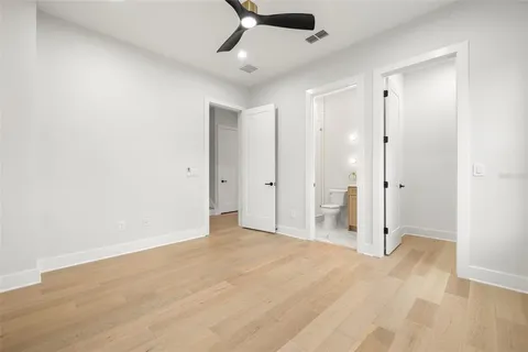 a view of kitchen with stainless steel appliances kitchen island a sink dishwasher a stove and a refrigerator with wooden floor