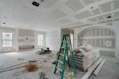 a bedroom with furniture and a wooden floor
