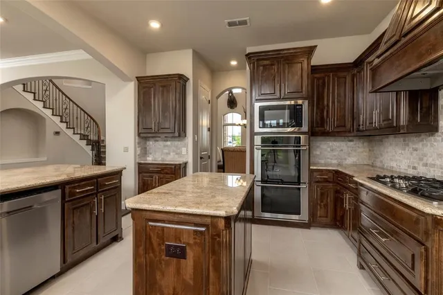 a kitchen with a stove and a refrigerator