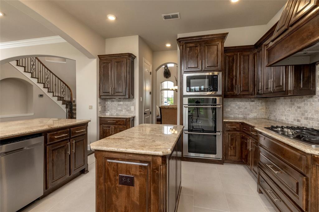 1413 Artesia Lane McLendon-Chisholm, TX 75032 - Photo 11 of 40 a kitchen with a stove and a refrigerator