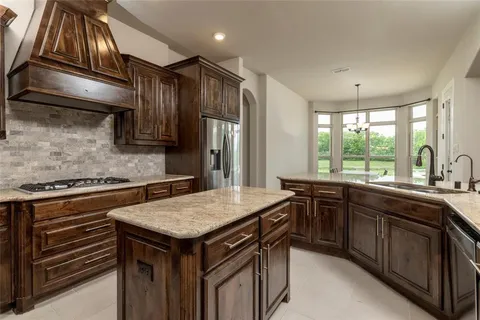 a kitchen with a stove sink and cabinets