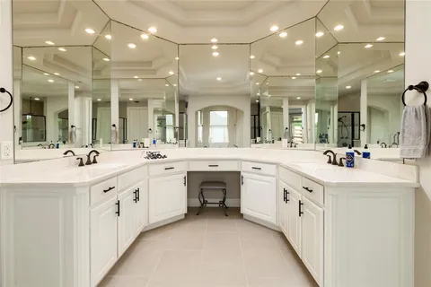 a large white bathroom with a large vanity and a sink