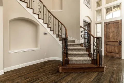 a view of entryway and hall with wooden floor
