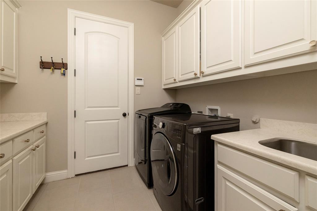 1413 Artesia Lane McLendon-Chisholm, TX 75032 - Photo 24 of 40 a utility room with dryer and washer