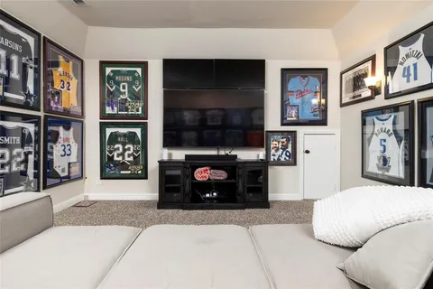 a living room with stainless steel appliances furniture a fireplace and a flat screen tv