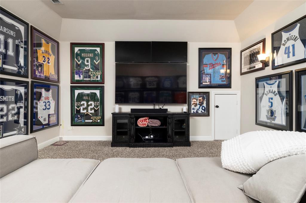 1413 Artesia Lane McLendon-Chisholm, TX 75032 - Photo 29 of 40 a living room with stainless steel appliances furniture a fireplace and a flat screen tv