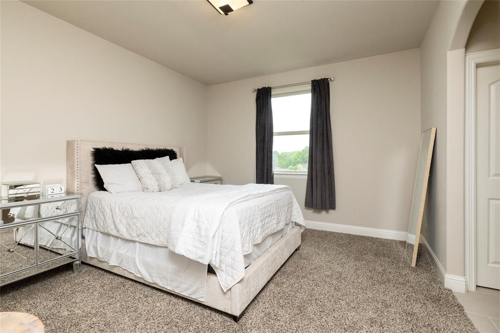 1413 Artesia Lane McLendon-Chisholm, TX 75032 - Photo 30 of 40 a large bed sitting in a bedroom next to a window