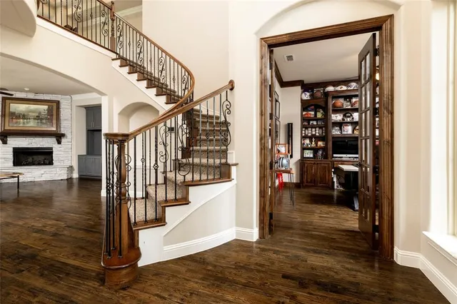 a view of entryway and hall with wooden floor
