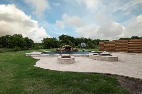 a view of a garden with lawn chairs