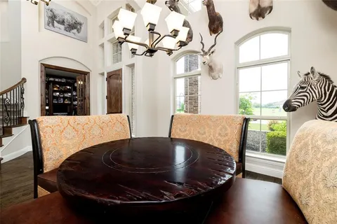a view of a dining room with furniture wooden floor and chandelier