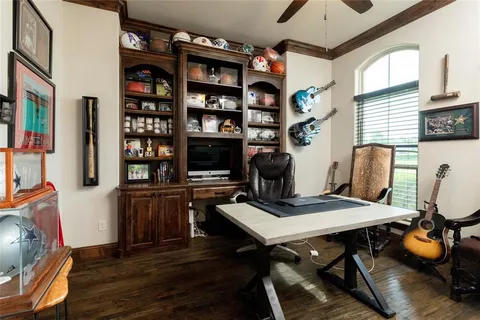 a view of a workspace with furniture and a window