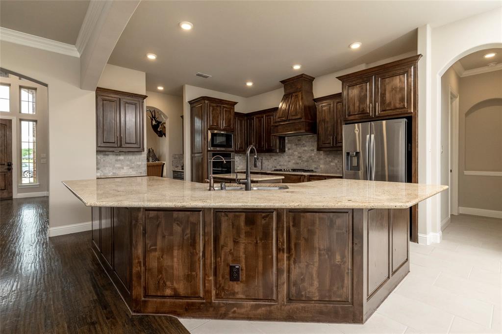 1413 Artesia Lane McLendon-Chisholm, TX 75032 - Photo 10 of 40 a large kitchen with kitchen island a sink stainless steel appliances and cabinets