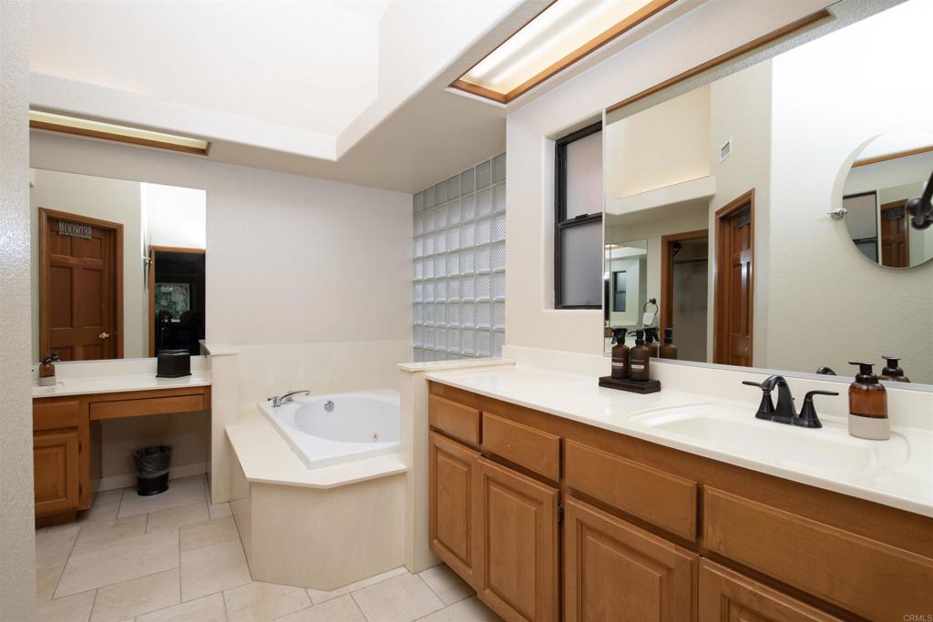 23509 Barona Mesa Road Ramona, CA 92065 - Photo 13 of 34 a bathroom with a tub sink and mirror