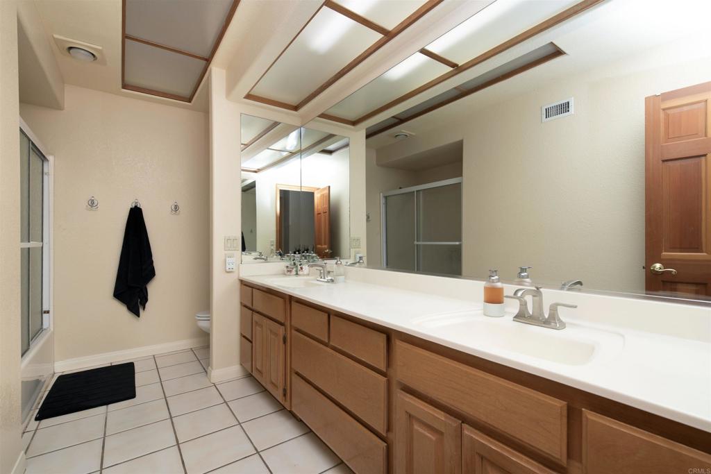 23509 Barona Mesa Road Ramona, CA 92065 - Photo 17 of 34 a bathroom with a sink and a mirror