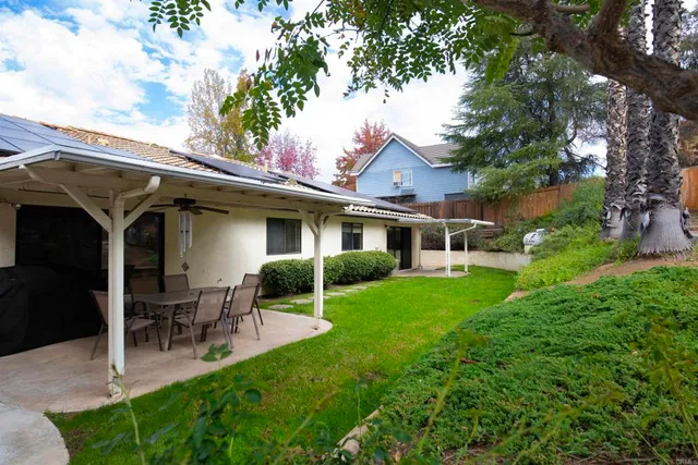 a front view of a house with a yard table and chairs