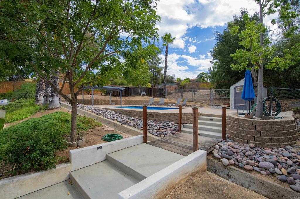 23509 Barona Mesa Road Ramona, CA 92065 - Photo 22 of 34 a view of a roof deck with couches and wooden fence