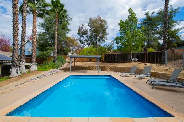 a view of a swimming pool with a lounge chair