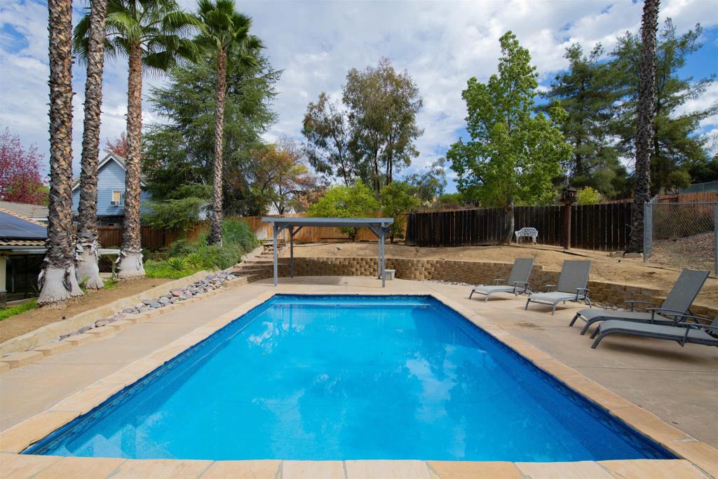 23509 Barona Mesa Road Ramona, CA 92065 - Photo 23 of 34 a view of a swimming pool with a lounge chair