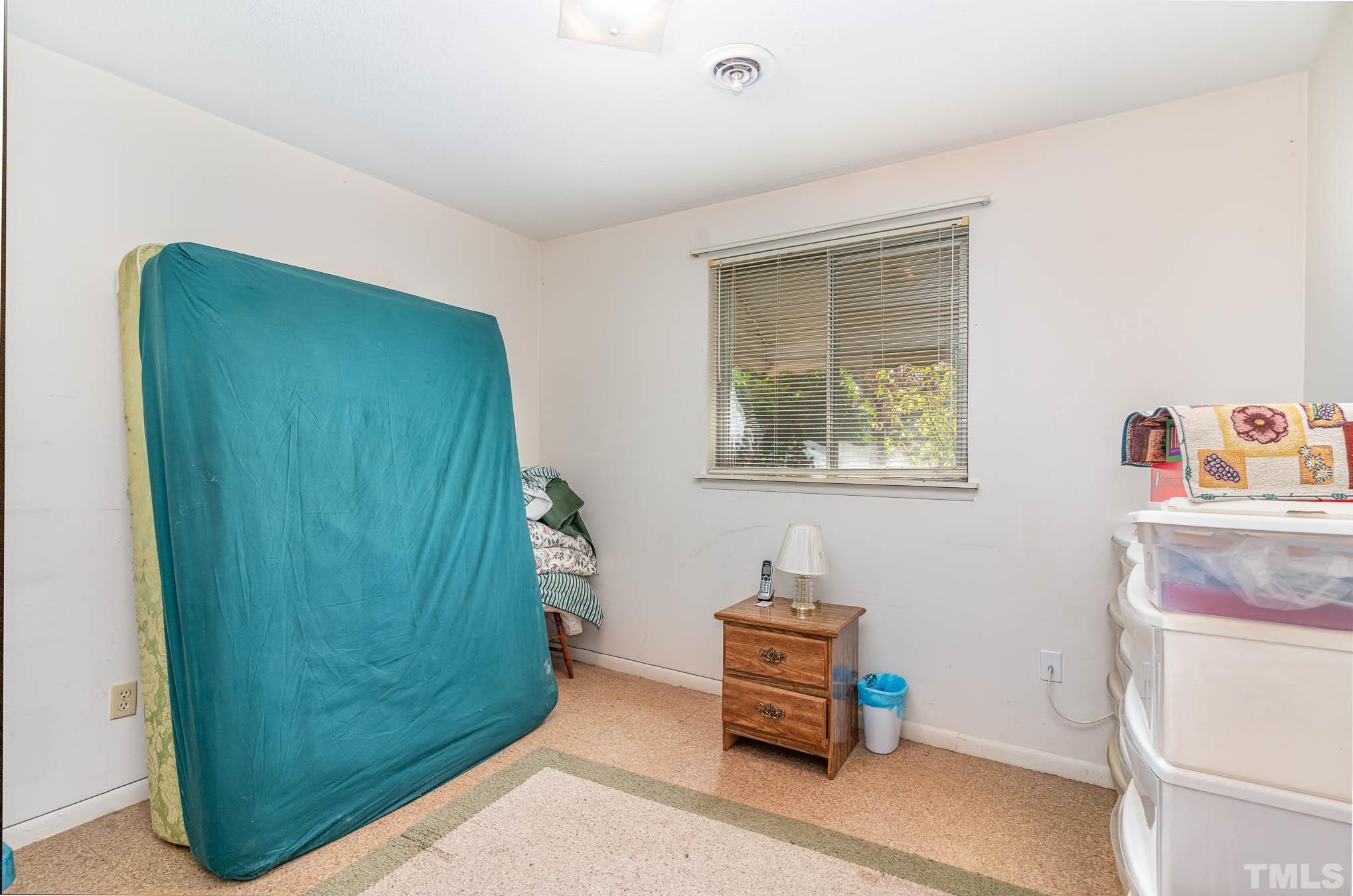 843 Hadley Road Raleigh, NC 27610 - Photo 11 of 28 a room with a window and a couch
