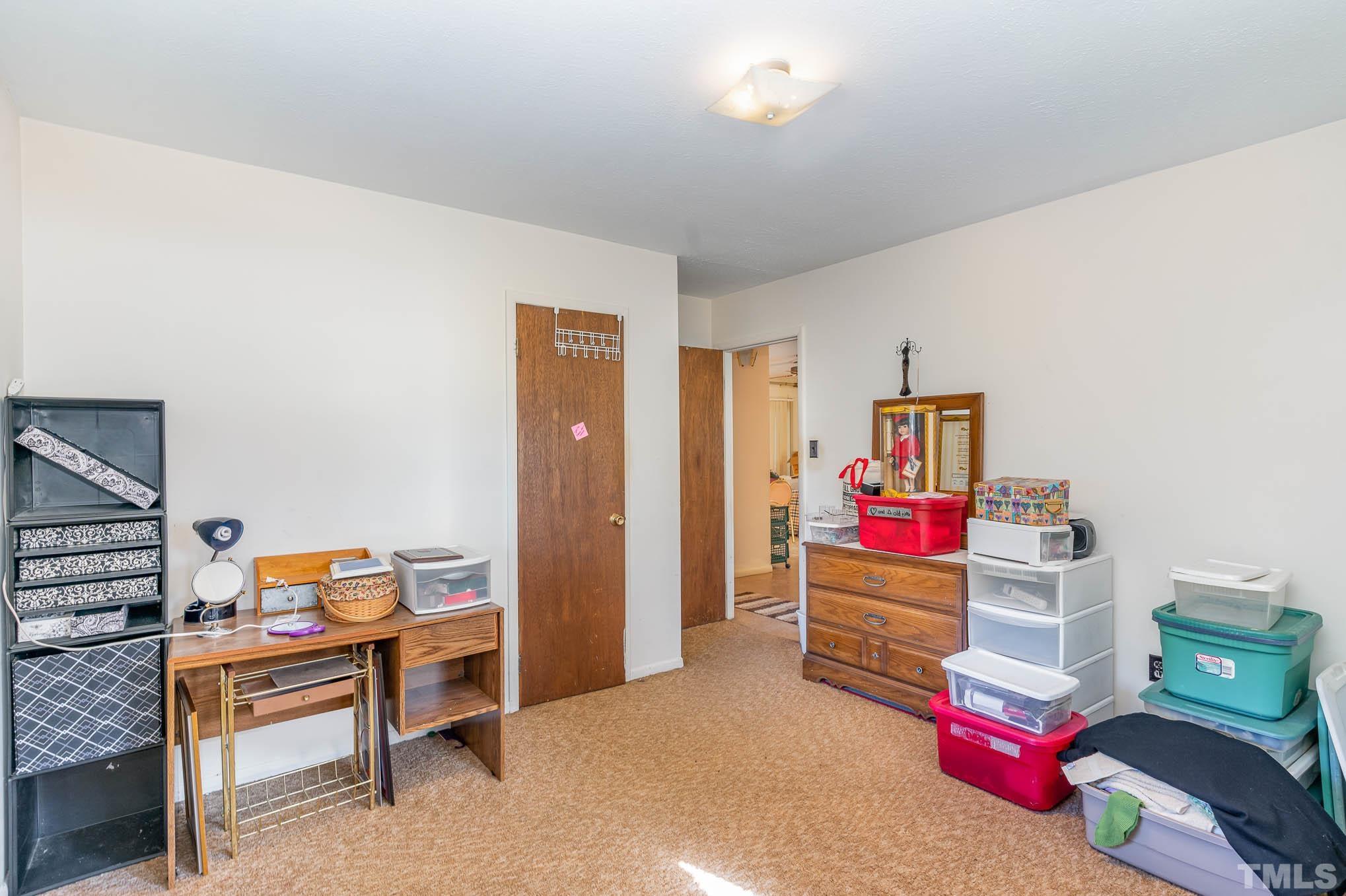 843 Hadley Road Raleigh, NC 27610 - Photo 13 of 28 a bedroom with furniture and a book shelf
