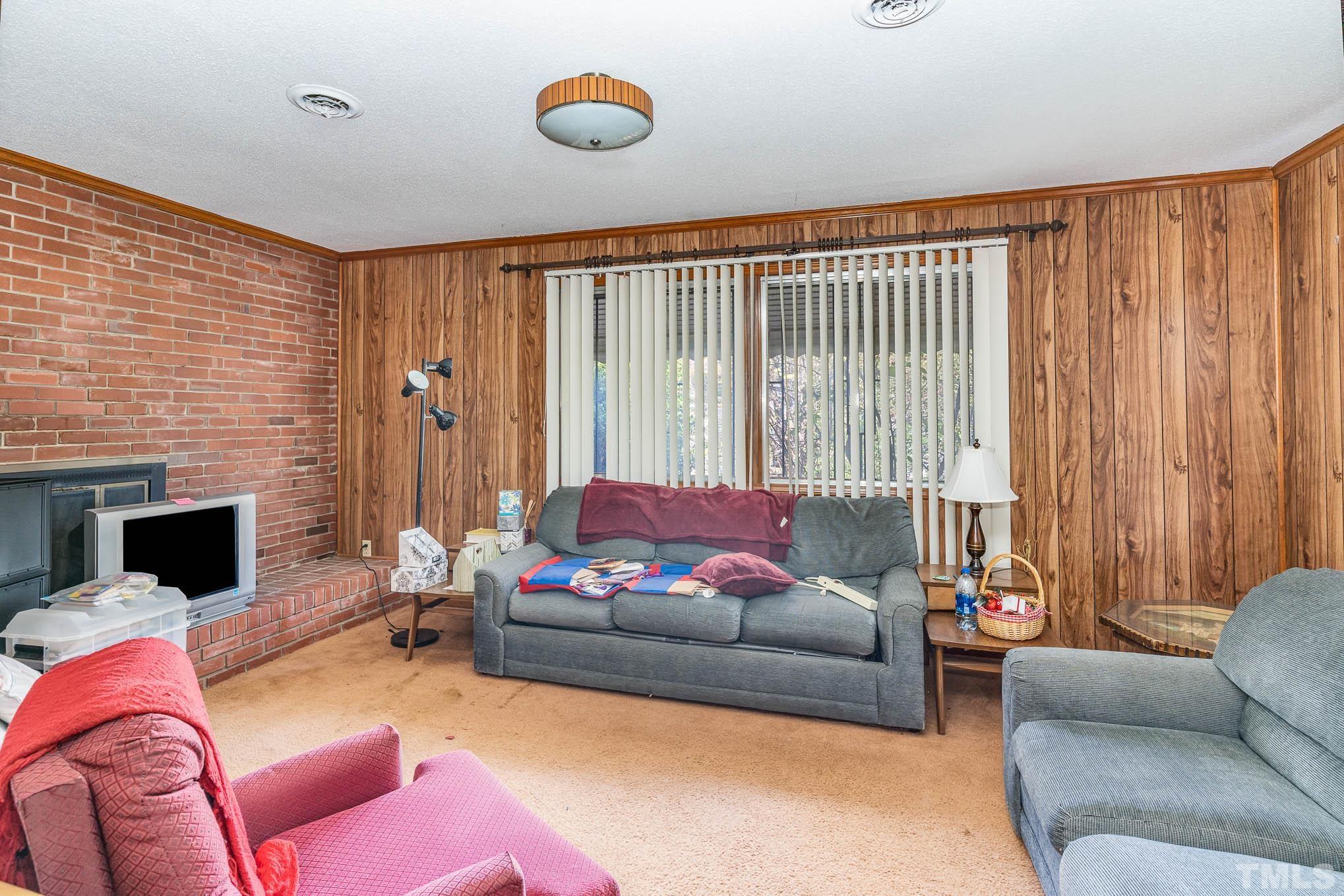 843 Hadley Road Raleigh, NC 27610 - Photo 19 of 28 a living room with furniture and a fireplace