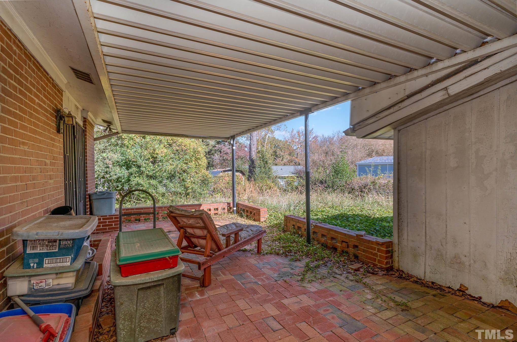 843 Hadley Road Raleigh, NC 27610 - Photo 26 of 28 a view of a patio with table and chairs and wooden floor