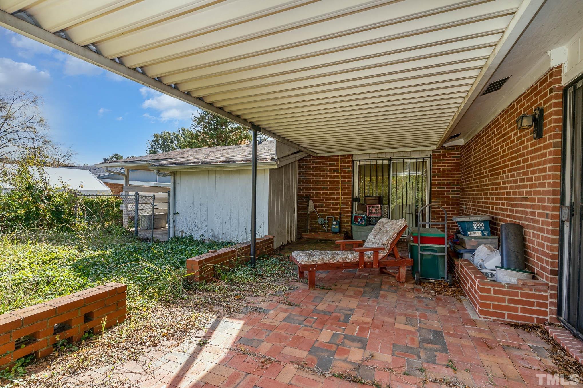 843 Hadley Road Raleigh, NC 27610 - Photo 27 of 28 a view of house with backyard and outdoor seating