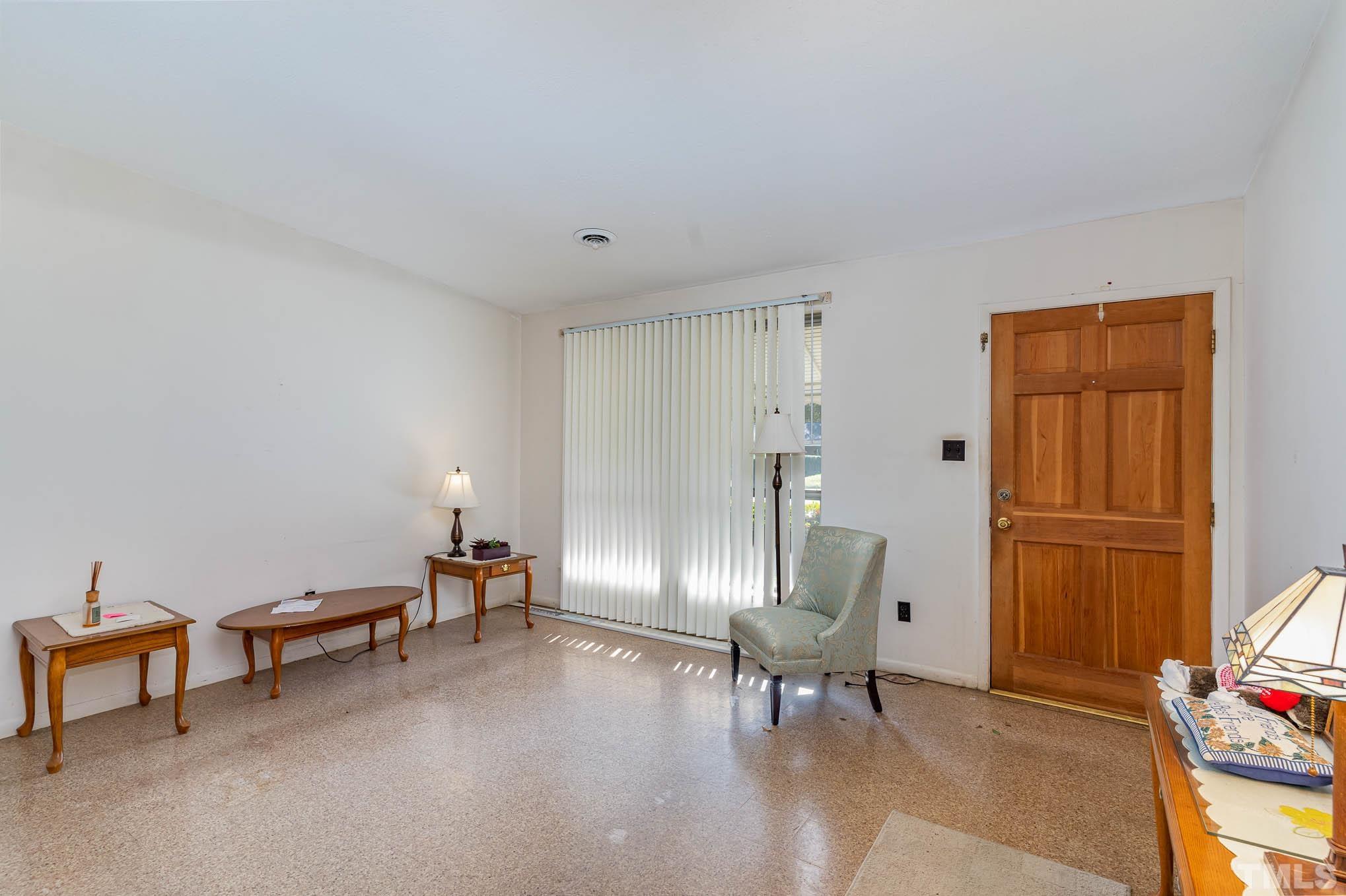843 Hadley Road Raleigh, NC 27610 - Photo 5 of 28 a view of a livingroom with furniture and a chair