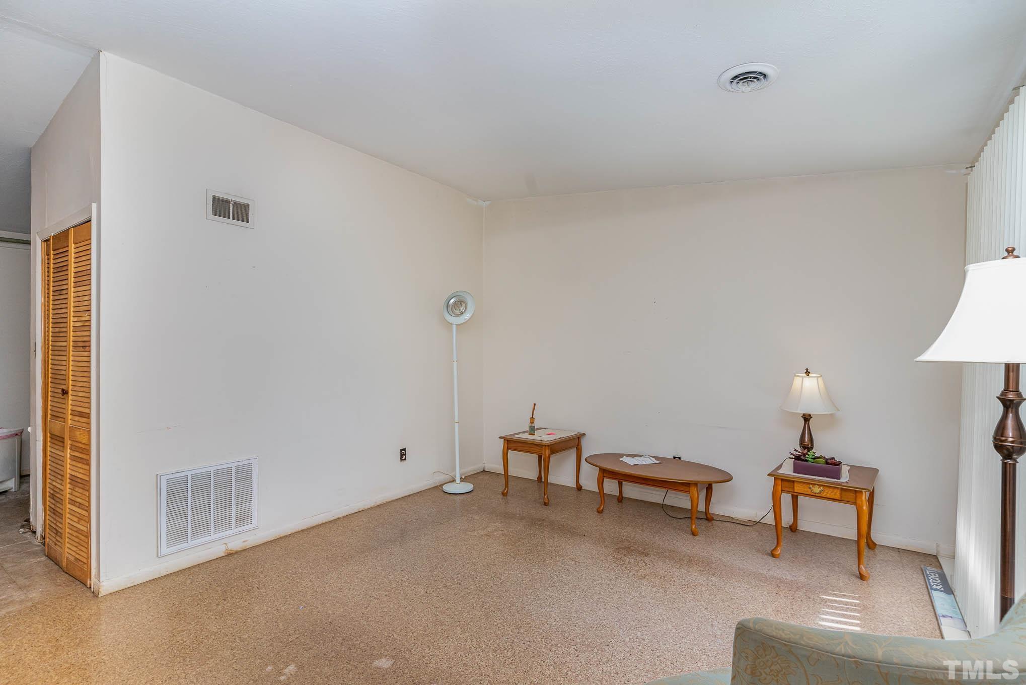 843 Hadley Road Raleigh, NC 27610 - Photo 7 of 28 a living room with furniture and a lamp