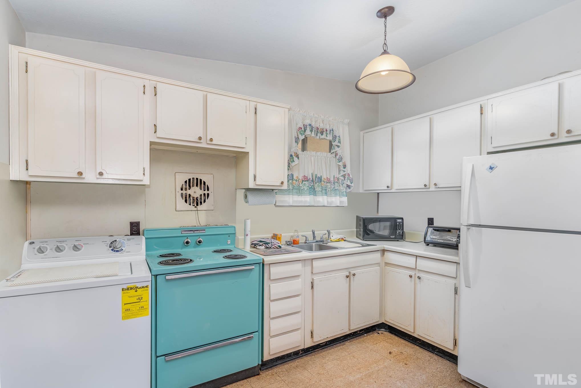 843 Hadley Road Raleigh, NC 27610 - Photo 8 of 28 a kitchen with a sink a stove and cabinets
