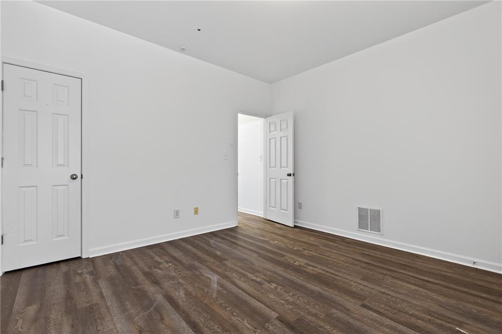 1644 Sandy Beach Point Lawrenceville, GA 30043 - Photo 12 of 60 a view of an empty room with wooden floor