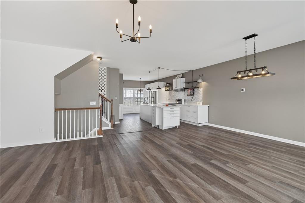 1644 Sandy Beach Point Lawrenceville, GA 30043 - Photo 14 of 60 a view of a room with wooden floor white walls and windows