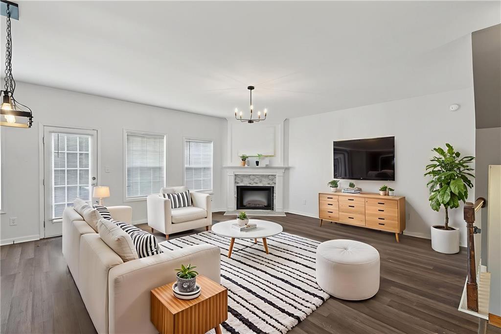1644 Sandy Beach Point Lawrenceville, GA 30043 - Photo 16 of 60 a living room with furniture a fireplace and a flat screen tv