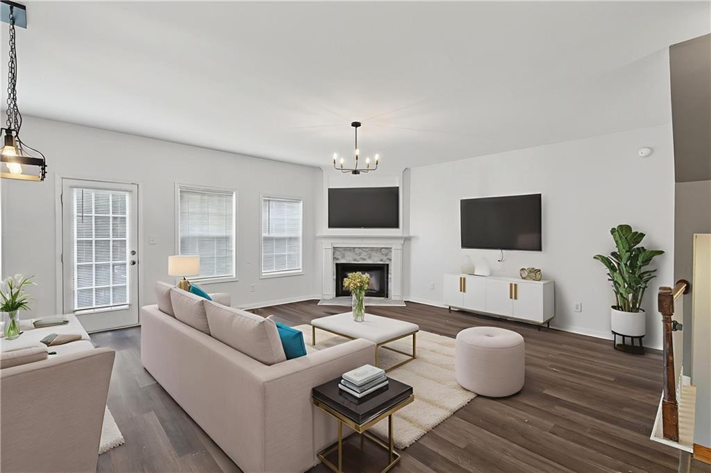 1644 Sandy Beach Point Lawrenceville, GA 30043 - Photo 17 of 60 a living room with furniture a fireplace and a flat screen tv
