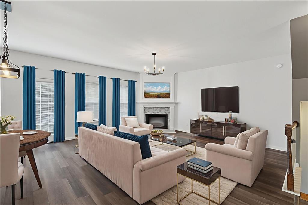 1644 Sandy Beach Point Lawrenceville, GA 30043 - Photo 18 of 60 a living room with furniture a fireplace and a flat screen tv