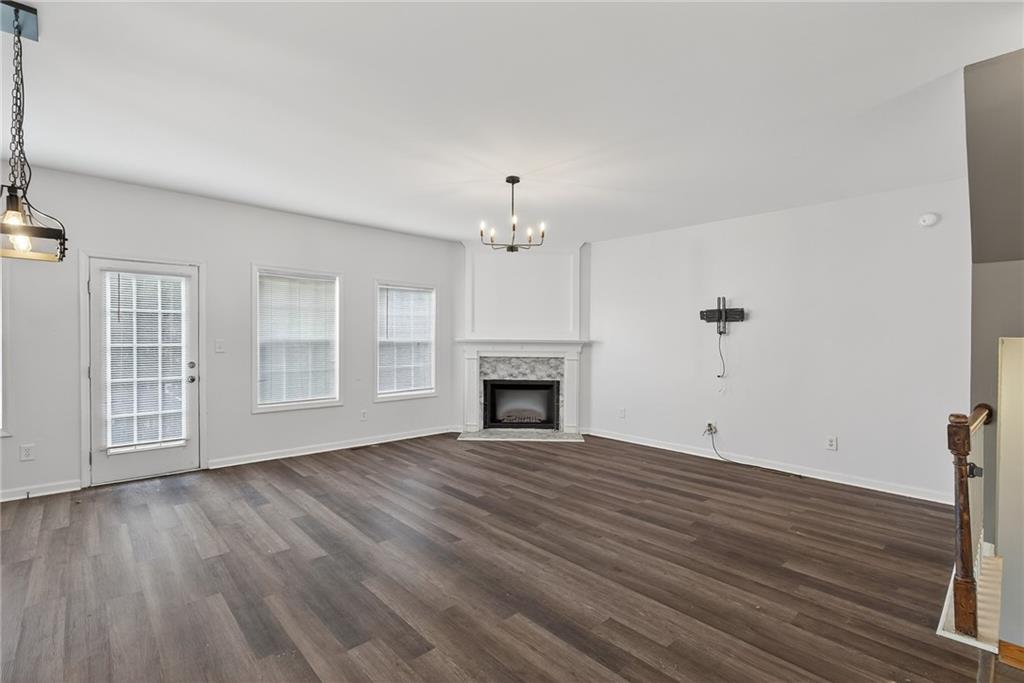 1644 Sandy Beach Point Lawrenceville, GA 30043 - Photo 22 of 60 a view of an empty room with wooden floor fireplace and a window