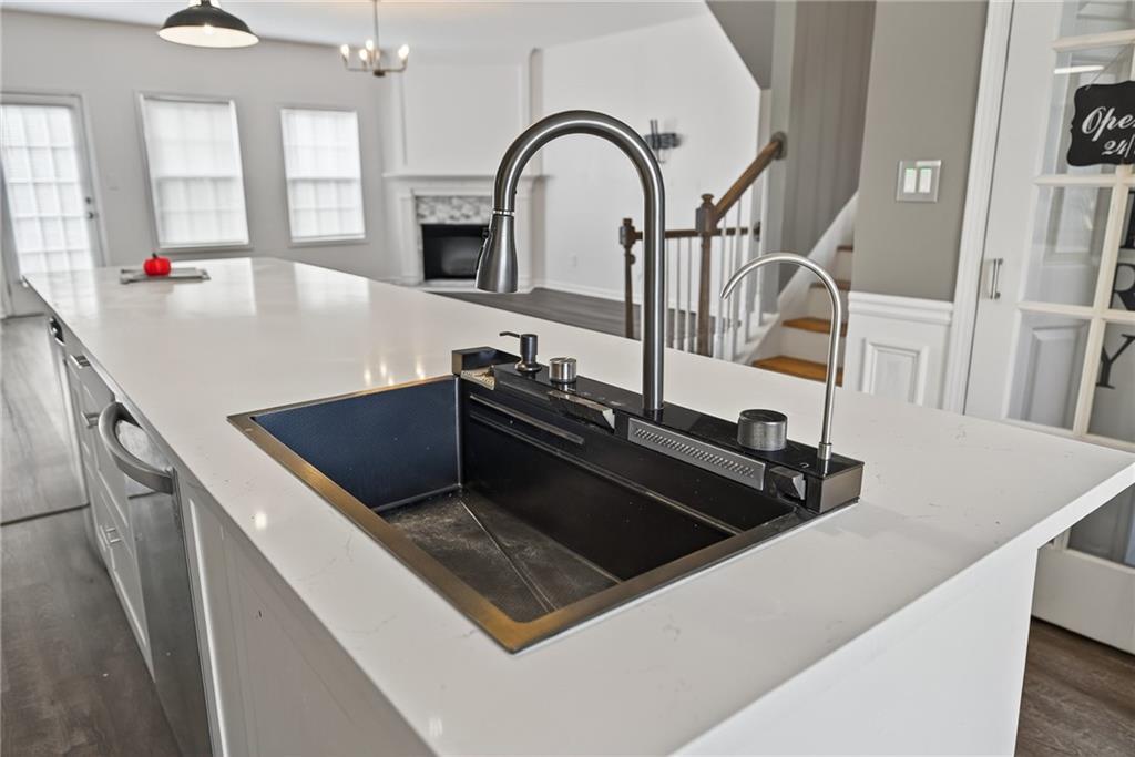 1644 Sandy Beach Point Lawrenceville, GA 30043 - Photo 26 of 60 a kitchen with kitchen island a sink appliances and a counter top space