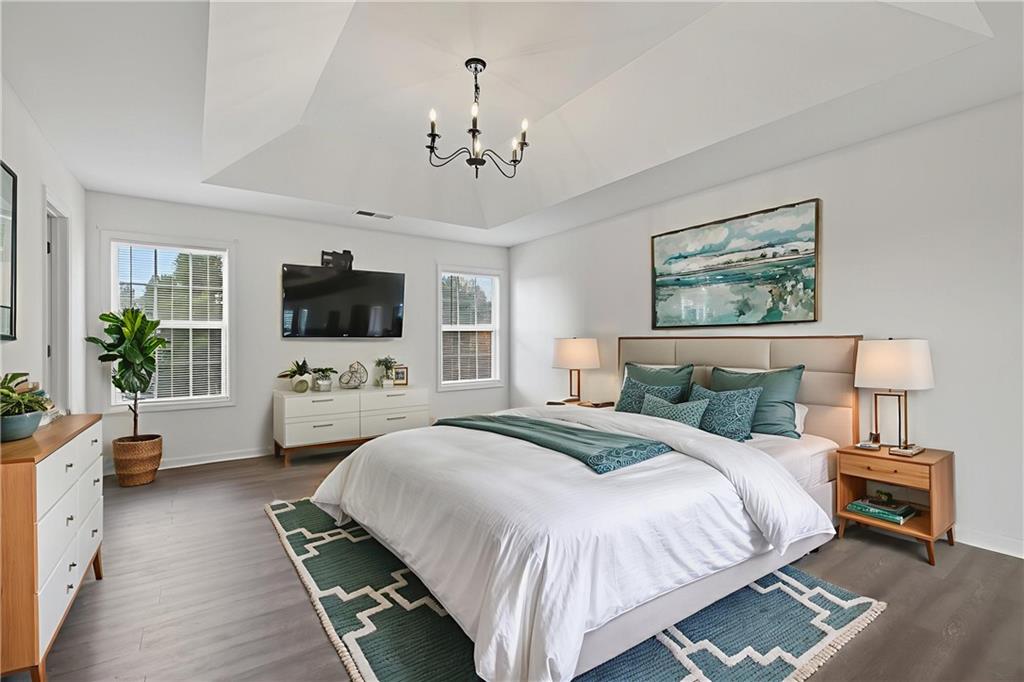 1644 Sandy Beach Point Lawrenceville, GA 30043 - Photo 37 of 60 a spacious bedroom with a bed and a flat screen tv