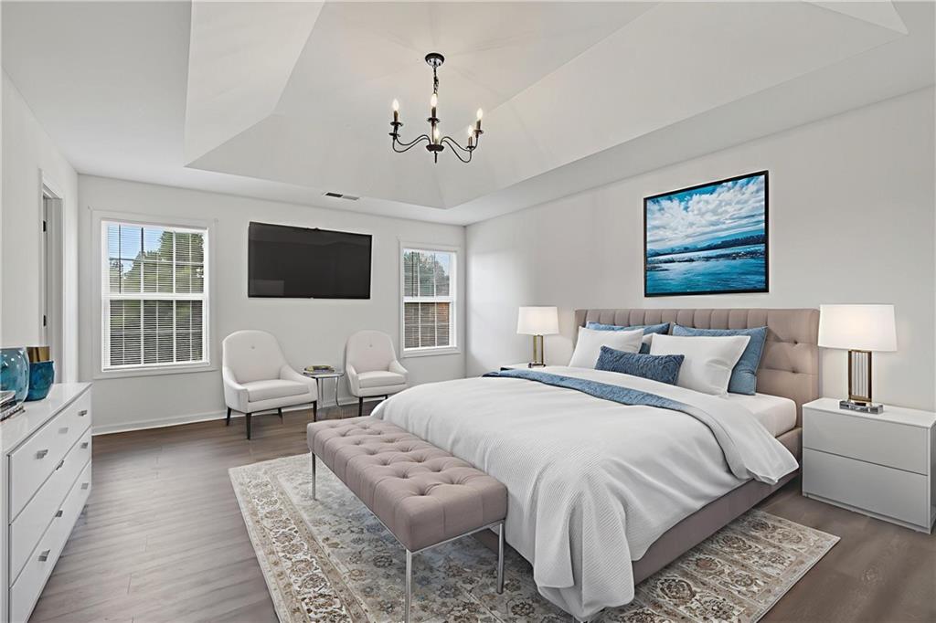 1644 Sandy Beach Point Lawrenceville, GA 30043 - Photo 39 of 60 a spacious bedroom with a bed a couch and large window