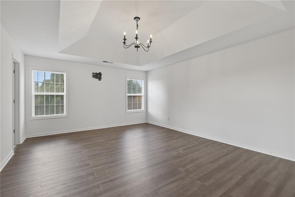 1644 Sandy Beach Point Lawrenceville, GA 30043 - Photo 40 of 60 a view of an empty room with wooden floor and a window