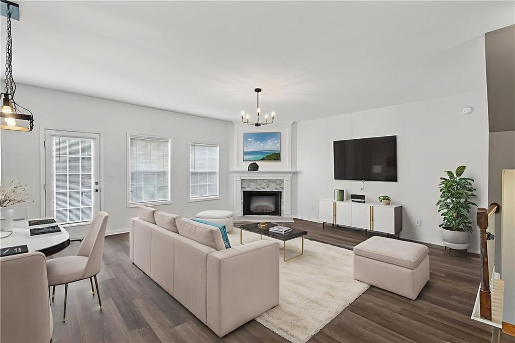 1644 Sandy Beach Point Lawrenceville, GA 30043 - Photo 4 of 60 a living room with furniture a fireplace and a flat screen tv